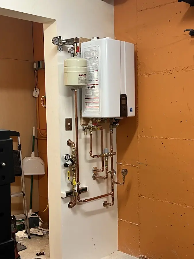 Plumbing technician inspecting water heater connections in Maple Heights-Lake Desire